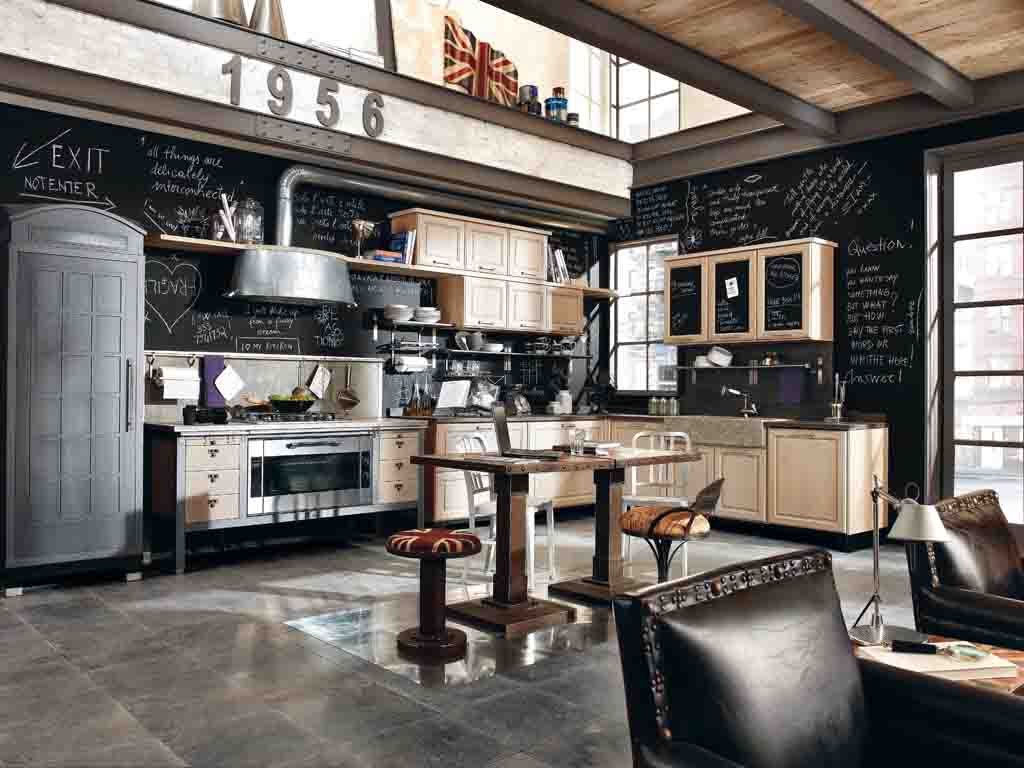 Marchi Group. Cucina 1956. In rovere spazzolato, sbiancato e rifinito. I pensili sono arricchiti da un particolare pannello in lavagna. I piani top sono disponibili in ciotoli, in marmo, in pietra serena, o in cemento.
