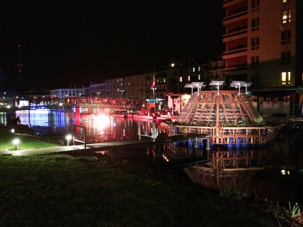 Notturna della serra modulare galleggiante Jellyfish Barge, ancorata in Darsena a Milano.