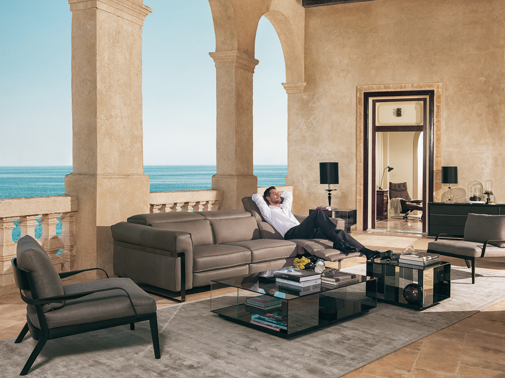 Natuzzi Italia. Divano Fidelio. Design architetti Manzoni e Tapinassi. La struttura in metallo ne esalta il design. I braccioli sono impreziositi da cuciture