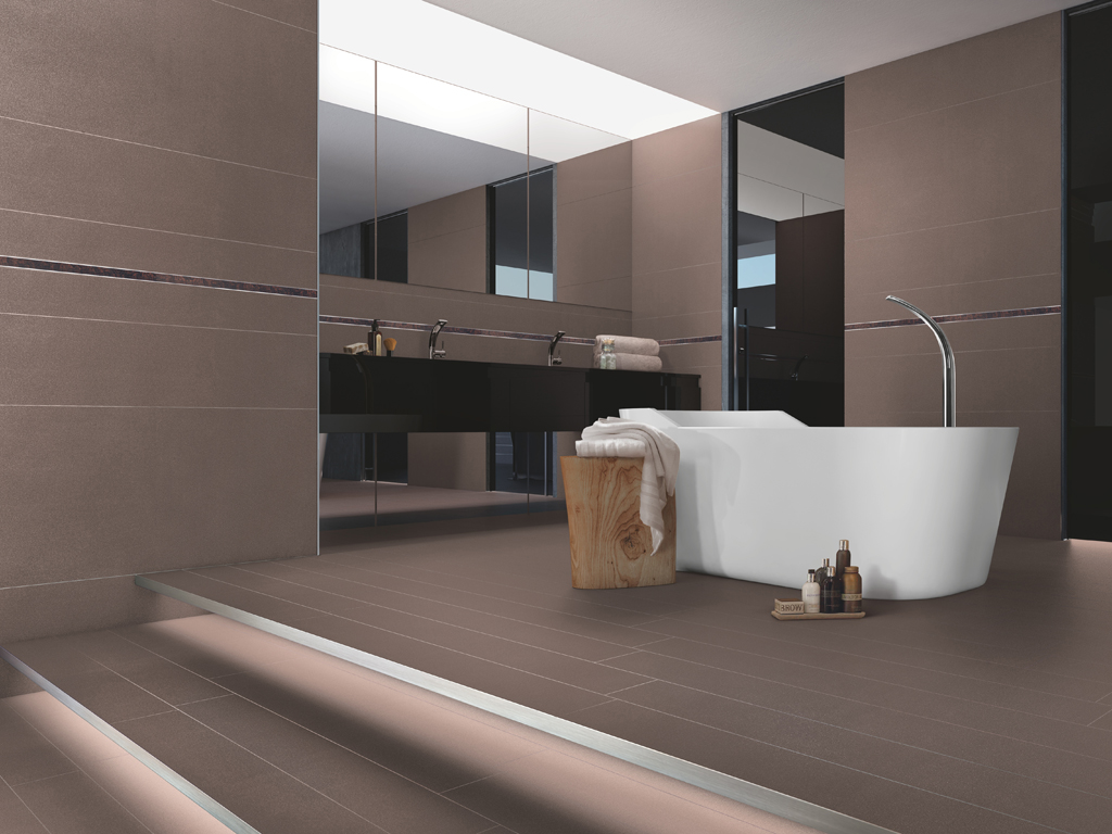 Casalgrande Padana. Earth by Pininfarina. Le piastrelle, prodotte in grès porcellanato, presentano un'esclusiva e ricercata texture e un potente effetto multisensoriale. Alla vista le superfici appaiono calde e rarefatte, mentre al tatto se ne apprezza l'innovativa micro-tridimensionalità. Nell'immagine: Metalred, Listello di Radica Silver.
