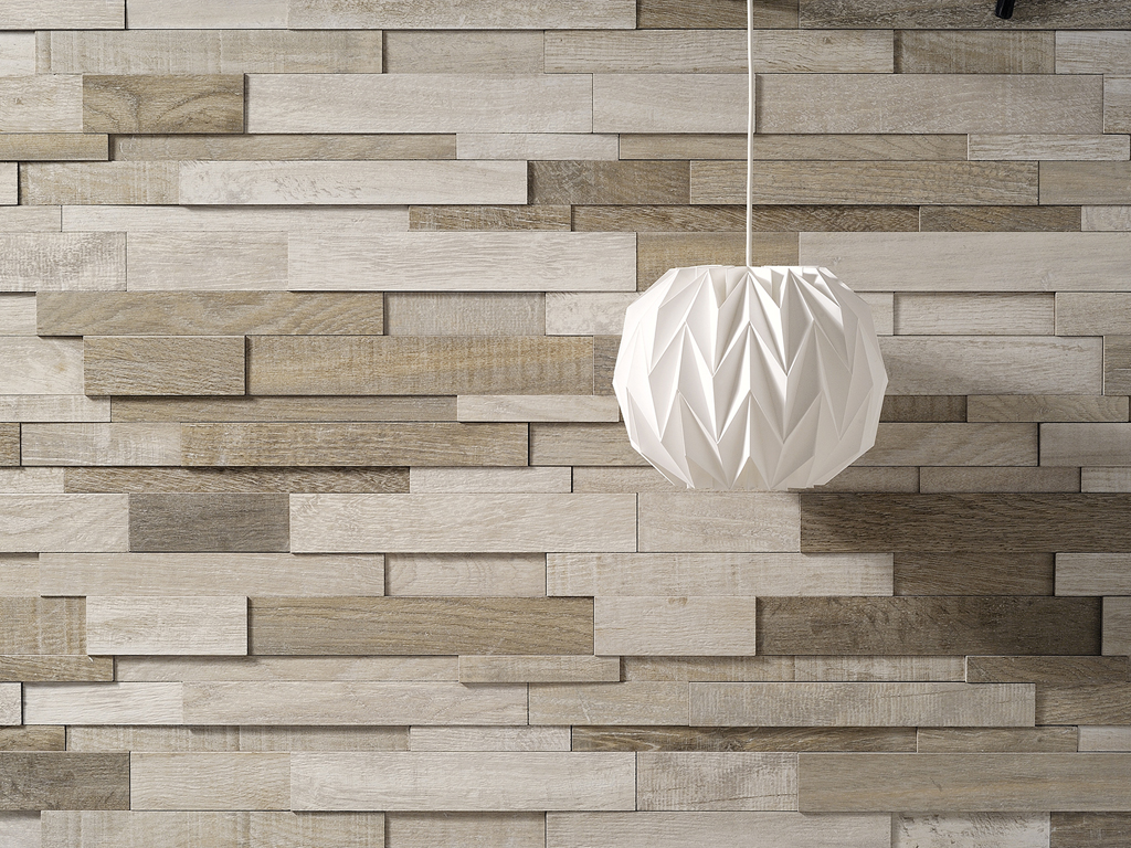 Ceramica Fioranese. Il tempo si posa sulle superfici e lascia le sue tracce. Nella collezione “Wood_Mood” la ceramica riprende le valenze estetiche del legno vissuto, calpestato, segnato e lo ricompone. In questo caso restituendoci una superficie tridimensionale che ben si adatta alla posa verticale. Un bassorilievo contemporaneo, un gioco di sfumature e di formati decisamente riuscito.