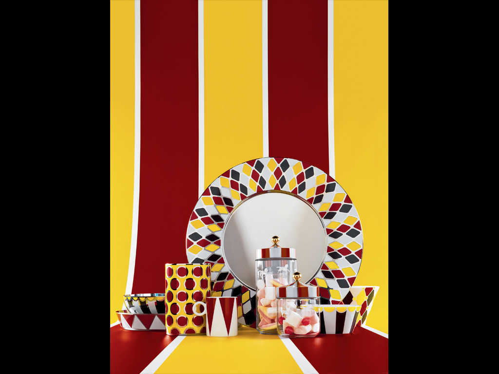 Alessi. Per i barattoli ermetici in vetro Marcel Wanders immagina una decorazione che ricorda le giostre dei cavalli spesso montate insieme al tendone del circo. Il coperchio è decorato con il disegno a spicchi bianchi e rossi tipico delle coperture delle giostre, mentre il pomolo dorato richiama l’elemento ornamentale che si staglia al loro centro. Il risultato è incantevole: Wanders trasforma i classici barattoli da cucina in allegre giostre miniaturizzate.
