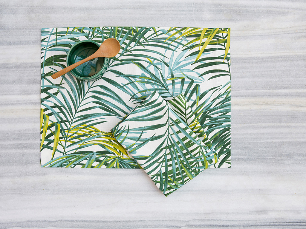 Milou Milano. “Palm Collection” diverse tonalità di verde tracciano sul tessuto le foglie di palma. Qui nella versione tovaglietta americana con tovagliolo. Irresistibili per una colazione estiva.