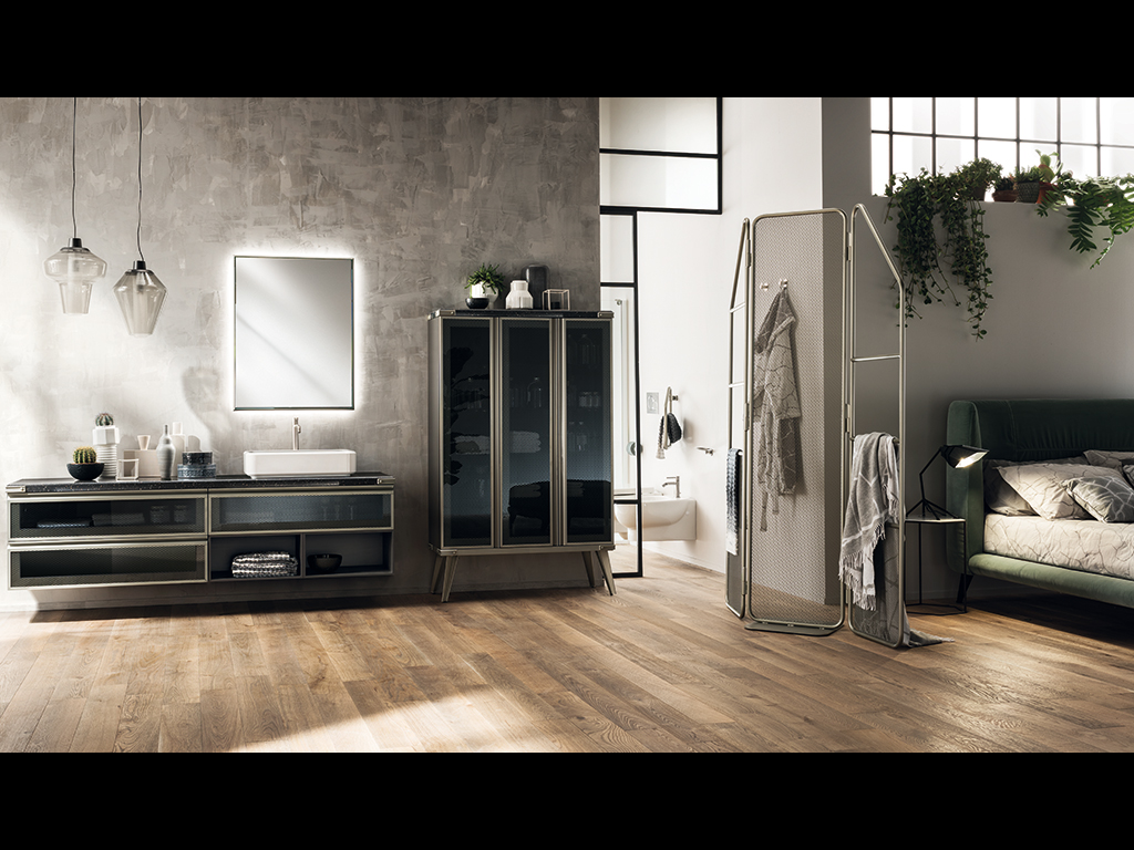 Scavolini Bagno. Nell’immagine, ambiente bagno arredato con il programma Diesel Open Workshop di Scavolini, realizzato in collaborazione con Diesel. La base è in Laccato Opaco Grigio Ferro con piano in Corian® Gravel. Soluzioni che arricchiscono la componibilità del programma d’arredo sono: la specchiera rettangolare Square Lunar su disegno Diesel con luce led, il lavabo Sink Rectangular in Mineralmarmo, finitura lucida. Sulla destra, il separé Total Screen con rete metallica e tubolare finitura Acciaio Soft.