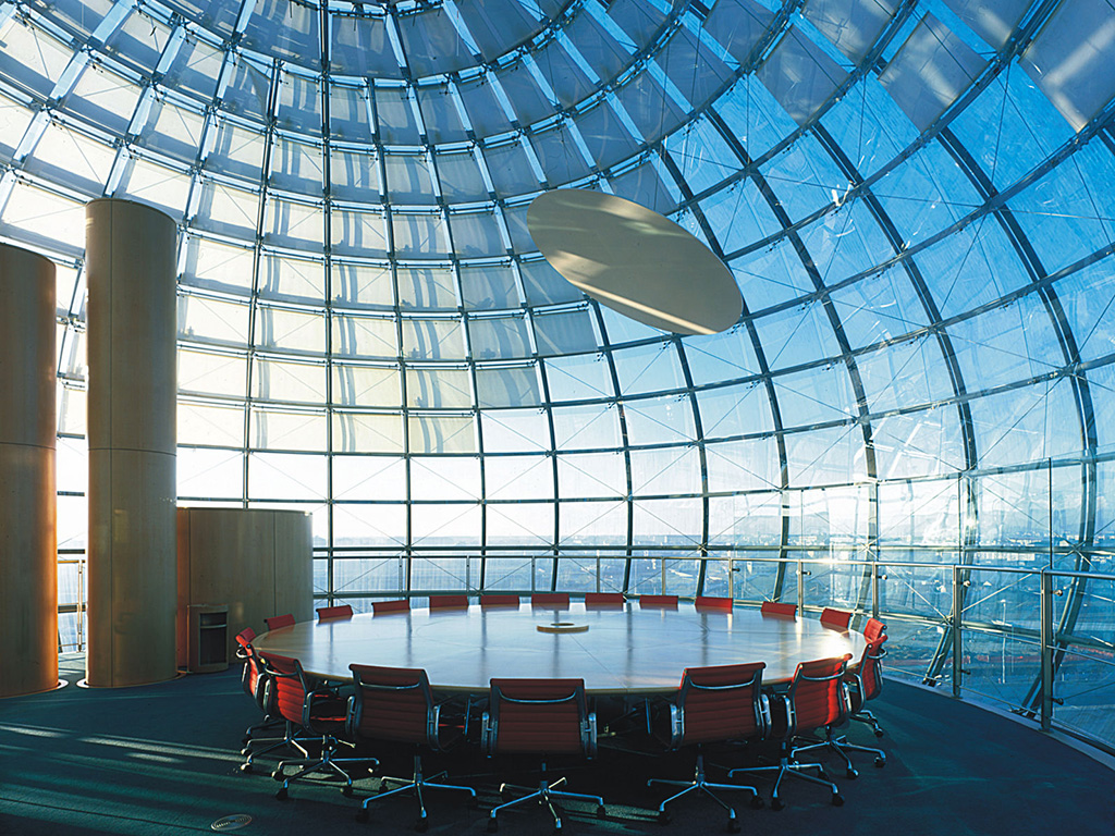 Conference bubble: beyond conference table is panoramic view of Turin; above it is titled disc that reflects light from uplighter. Blinds shield sunlight where it falls directly on dome. Courtesy RPBW, Renzo Piano Building Workshop. (Ph. ©Denancé Michel)