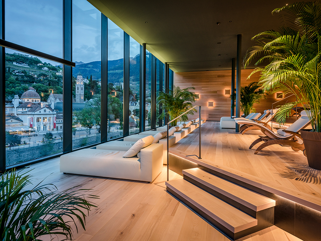 Hotel Terme Merano. Un’altra immagine dell’area relax nella Sky SPA. L’atmosfera è rilassante e suggestiva. Predomina il legno di cedro nobile ed è dotata di lettini confortevoli.
