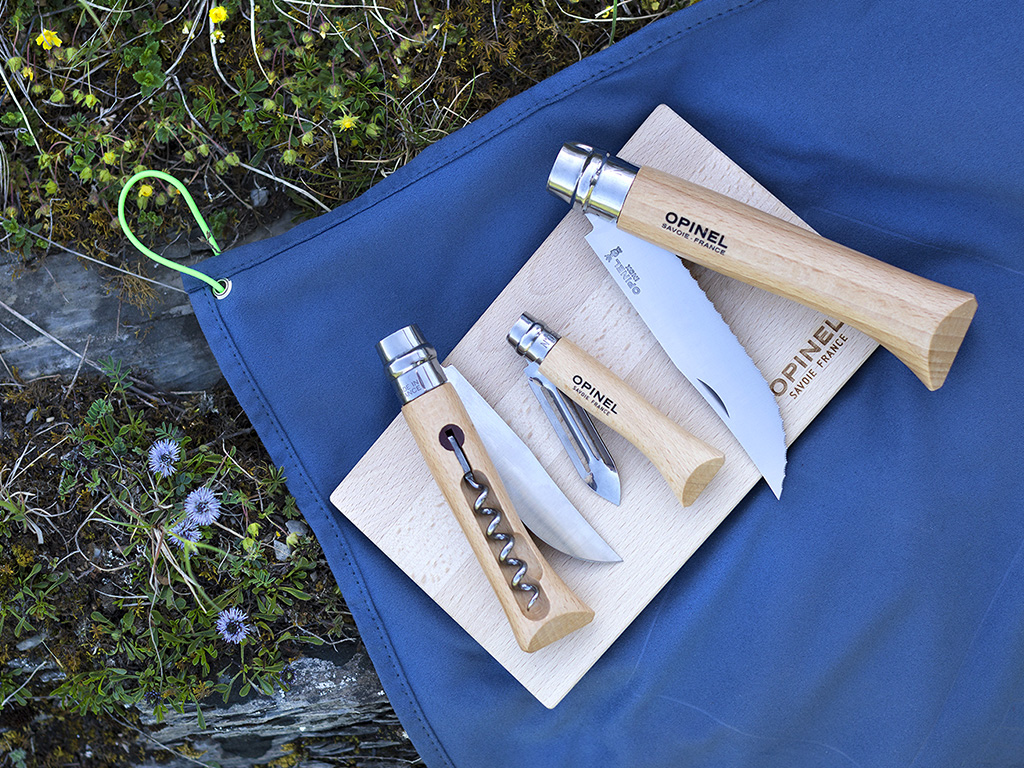 Opinel. Il “Kit Cuisine Nomade” è un set compatto e geniale di utensili dedicati alla preparazione dei pranzi fuori casa. Si compone di tre coltelli - un coltello cavatappi, un pelaverdure, un coltello a lama seghettata - e di due accessori: un tagliere in legno e un panno in microfibra per riporre e trasportare il set. Il panno funge anche da tovaglietta o da canovaccio. I manici sono realizzati in legno di faggio, le lame in acciaio inox.