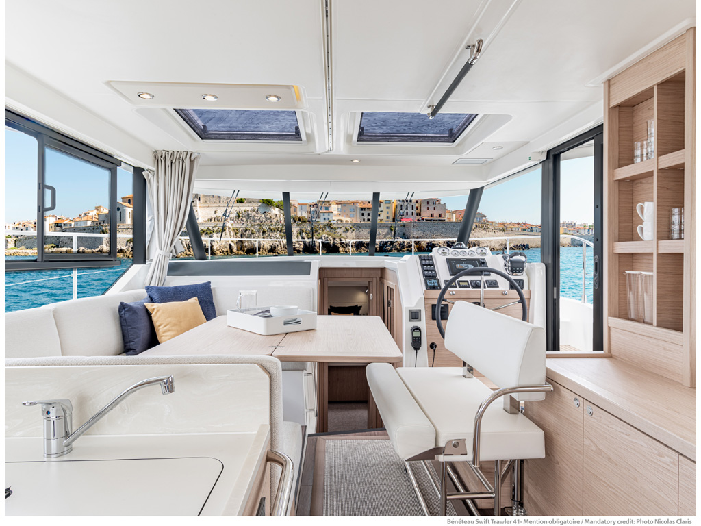 Bénéteau. Swift Trawler 41. Gli interni sono molto luminosi, accoglienti e funzionali. La cucina è posizionata verso poppa n collegamento diretto con il pozzetto che dispone di un divanetto scorrevole che facilita il passaggio verso la piattaforma bagno. Photo Nicolas Claris.