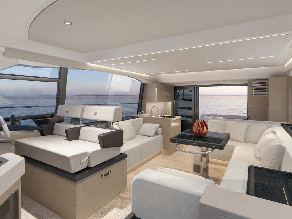 Bénéteau. Modello Monte Carlo 52. Il salone. Ampio spazio conviviale, area cucina collegata al pozzetto e postazione di guida rialzata. Protagoniste le ampie vetrate che regalano una visuale del mare a 360°. La visuale da prua perso poppa.