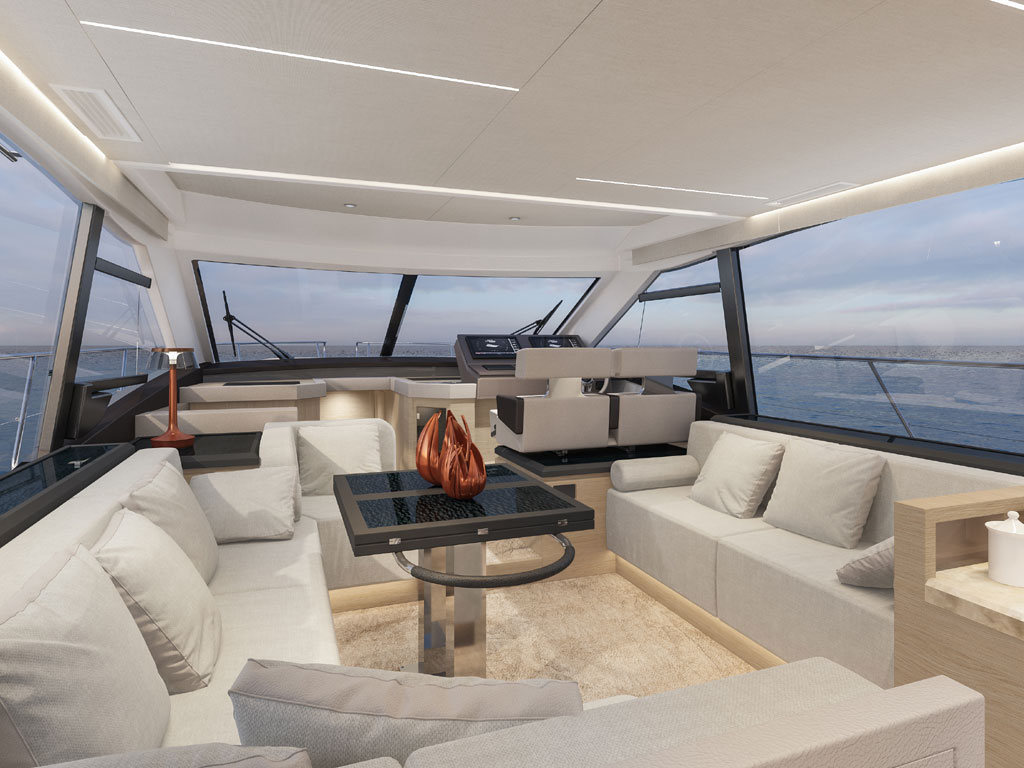 Bénéteau. Modello Monte Carlo 52. Il salone. Ampio spazio conviviale, area cucina collegata al pozzetto e postazione di guida rialzata. Protagoniste le ampie vetrate che regalano una visuale del mare a 360°. La visuale da poppa verso prua.