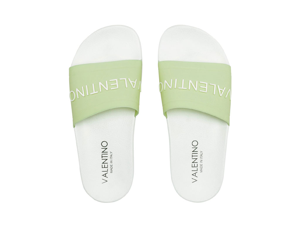 Valentino - Design Mario Valentino. Sandalo slider donna con fascia in PVC pastel green e maxi-logo lettering bianco in rilievo. Comodo plantare sagomato in gomma super-light. Prezzo: euro 130,00.
