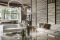 Living Divani. Il primo ambiente giorno introduce nel raffinato mondo Living Divani giocando sul rimando visivo tra il divano Lipp, reinterpretazione della pregiata lavorazione capitonné con lo spirito geometrico contemporaneo tipico del marchio, e il nuovo divano Easy Lipp che ne riprende i tratti caratteristici stemperandoli, come la trapuntatura e la gamba metallica slanciata, plasmando gli ambienti con personalità e leggerezza. Completano la scena i tavolini centro stanza Plane di Massimo Mariani,  i tavolini B3 di Victor Vasilev, e il tavolino Starsky di David Lopez Quincoces. (ph Santi Caleca)