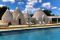 Relais Villa Aieni. Valle d’Itria. San Vito dei Normanni. I “sei coni” che costituiscono la vecchia struttura, si affacciano sulla piscina, lunga 15 metri, ideale per chi ama il nuoto e per i bambini ai quali è stata riservata una zona poca profonda.