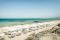 Is Arenas Nature & Charme Resort. La spiaggia privata dal resort si raggiunge attraverso una sentiero che conduce all’area VIP, piccoli gazebo e baldacchini con comodi materassi e all’arenile attrezzato, nell’immagine, con lettini, teli mare e ombrelloni.