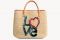 Ermanno Scervino. Ricami lettering vintage-like rendono unica questa shopping bag in rafia con preziosi interni multicolor.