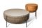 Poltrona Frau. La coppia di architetti e designer Gam Fratesi reinterpreta il cestino da cucito con “Cestlavie”. Fasce di cuoio Saddle Extra abilmente intrecciate a mano danno forma all’involucro sostenuto da una struttura in acciaio e completato da un piano d’appoggio in pelle che si apre al centro.