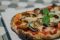 Prima Milano. Nell'immagine La Pinsa di Prima, rivisitazione della classica pizza. Una miscela di tre farine con un alto tasso di idratazione ed una lunga lievitazione con lievito madre. Il risultato è un prodotto diverso per forma, per gusto e fragranza, per leggerezza e digeribilità.