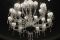 Barovier&Toso. La collezione “Président” si caratterizza per le diverse lavorazioni del vetro e dei pendagli di fattura originale. I sei lampadari della collezione sono disponibili con dodici, quattordici, diciotto, ventiquattro e trentasei luci: la versione a diciotto luci è declinata in due altezze diverse, mentre la versione a trentasei luci è ideale per le grandi scale. Sono due le lampade da parete, con una o due luci. Le finiture sono in cromo lucido.