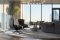 Benning Design Construction. Una vista dell’area conversazione. Qui si è accolti da due poltrone relax firmate Mario Bellini (423 Cab lounge, produzione Cassina) e da un divano modulare con numerose sedute, posizionate sia verso l’interno, sia verso l’esterno dell’attico. Il lampadario “Horus Suspension Light”, prodotto da BRABBU design forces, ha una struttura in ottone laccato nero opaco e paralumi  in “crackle glass”, una particolare lavorazione del vetro a effetto ghiaccio.