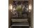 Benning Design Construction. Nell’ingresso: consolle in bronzo, acciaio inox e legno, posta su uno sfondo in pietra.