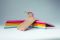 Toscanini. Linea “Confetti”. Portabiti modello “Irene” in legno di faggio non trattato, con gancio e parte inferiore colorati. Sono pensati per aggiungere un tocco pop al guardaroba. Proposti in una sola misura (cm 43 x 1.2) e nei colori: arancione, red cherry, fucsia e dusty blue, giallo intenso, verde menta. Disponibili online in confezione da 9 pezzi a Euro 43,90.
