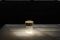 Flos. “Last Order” è una piccola lampada da tavolo (è alta circa 14 cm) portatile e ricaricabile. La luce che emana è diffusa attraverso una base in vetro solido trasparente, la cui forma richiama la tipologia architettonica della colonna greca. Il vetro è disponibile in due versioni: a superficie liscia, o scanalata (nella foto). La copertura è disponibile in diverse combinazioni di finiture metalliche e colorate: rame satinato e ottone per la versione da interni, inox lucido e verde opale verniciato per l’utilizzo in esterno. Fonte luminosa: LED 2,5W – 200lm – 2700K - CRI 90. Design Michael Anastassiades.
