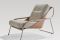 Zanotta. Maggiolina, chaise longue, design Marco Zanuso, 1947. Struttura in tubolare d’acciaio inox 18/8 lucidato, o nichelsatinato colore naturale o nero, oppure verniciato nero. Braccioli e scocca in cuoio pigmentato 90 bianco o nero. Due morbidi cuscini - in Ecofire, pelle o in tessuto - con imbottitura in piuma d’oca per lo schienale e in poliuretano/ Dacron Du Pont per la seduta. Dimensioni poltrona (LxPxH): 71x105x83 cm. Si completa con pouf (LxPxH): 65x65x38 cm. Prezzo: su richiesta.