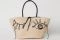 H&M. Shopper in cartapaglia con due manici, chiusura con laccetto da annodare in eco pelle, pon-pon applicati su un manico e motivo a filo.